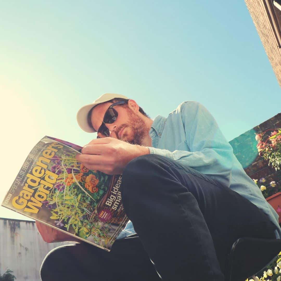 Eoin Dolan reading gardening world magazine