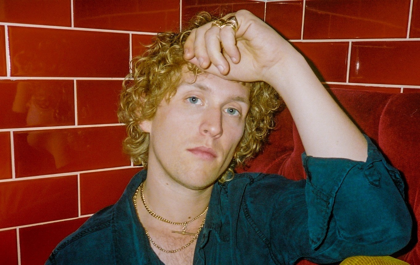 RHODES with red tiled wall behind
