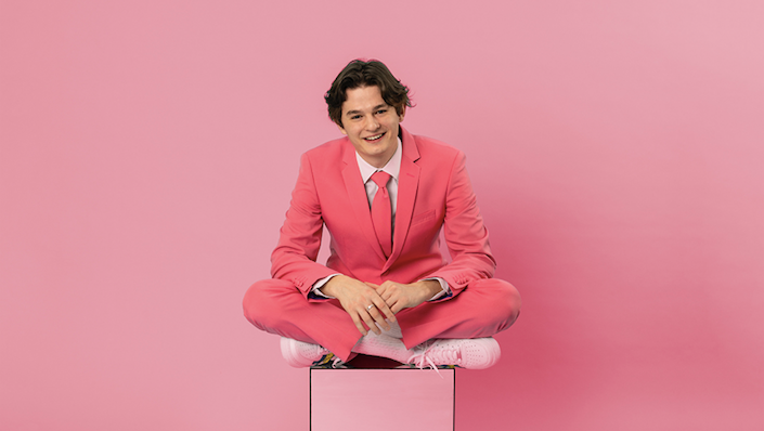 sam and sounds press photo for 'weird day' - dressed in pink in front of pink back drop
